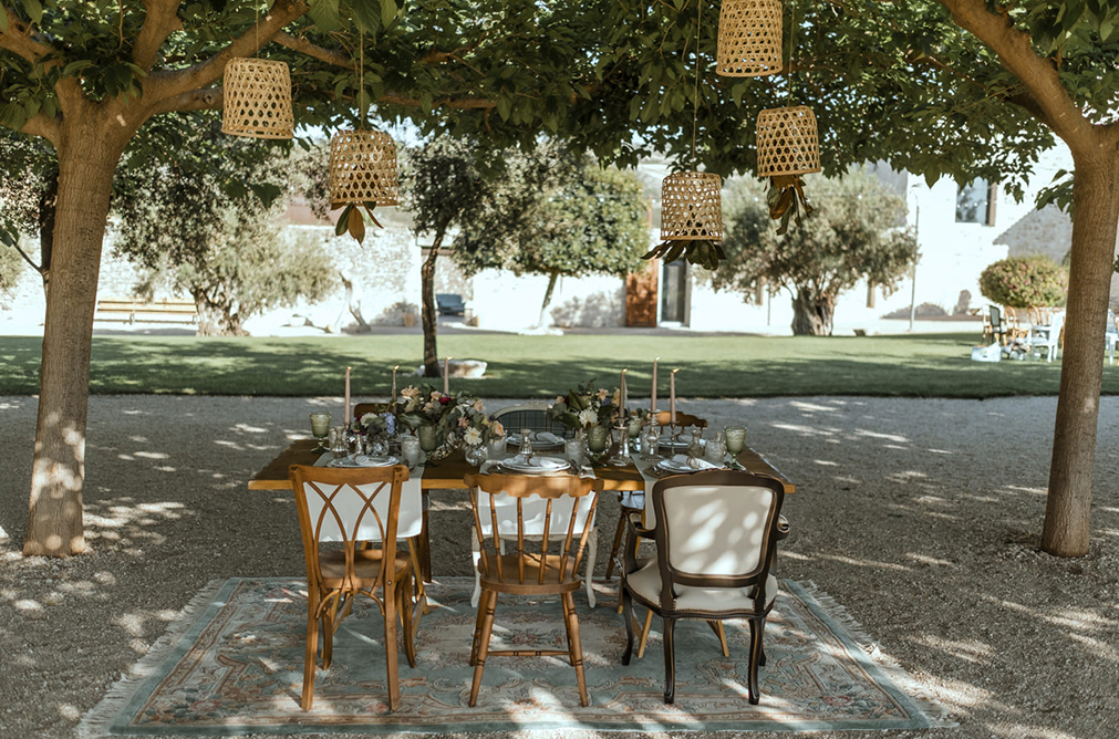 The wedding reception was an outdoor one, with woven lamps and a cozy styled table