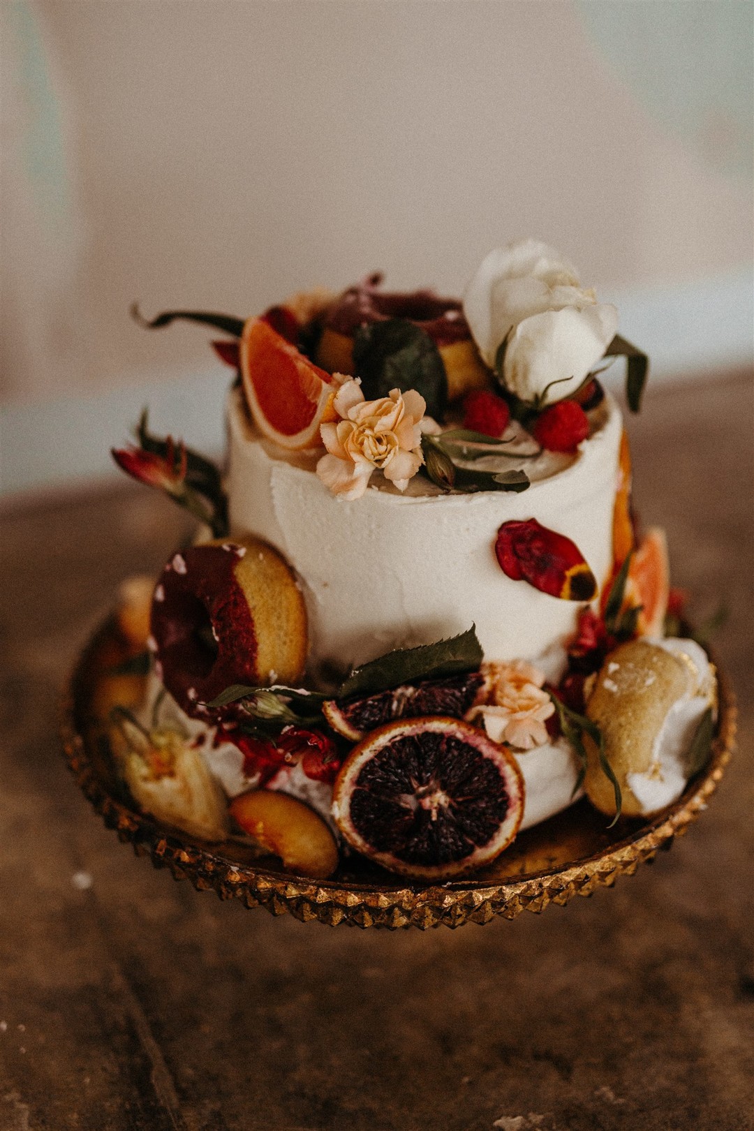 The wedding cake was a white textural one, with fruit fruits, blooms, greenery and foliage