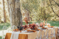 06 The wedding reception was done in bold sunset shades and with woven cages over the table