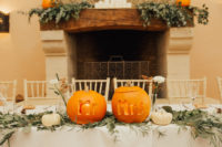 07 The reception table was decorated with pumpkins in orange and white, carved ones and greenery