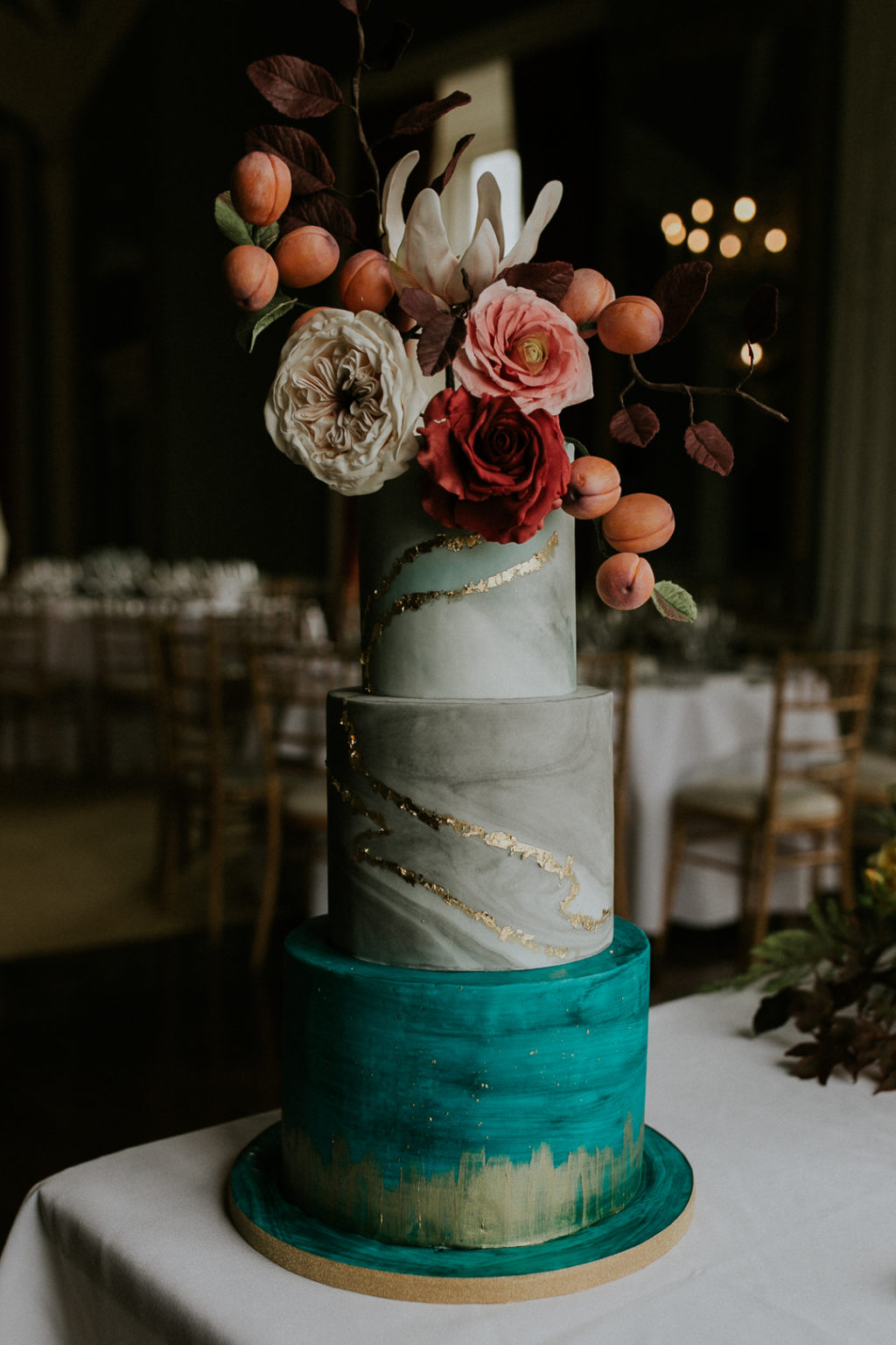 The wedding cake was a grey marble one, with a bold turquoise tier, metallic touches, lush blooms, foliage and apricots