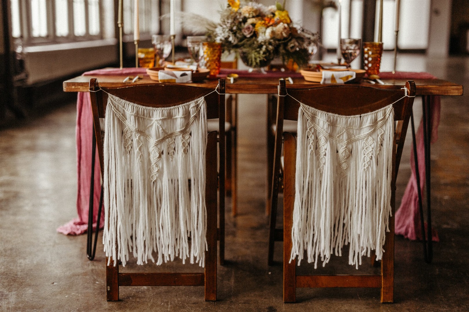 The wedding chairs were decorated with white macrame
