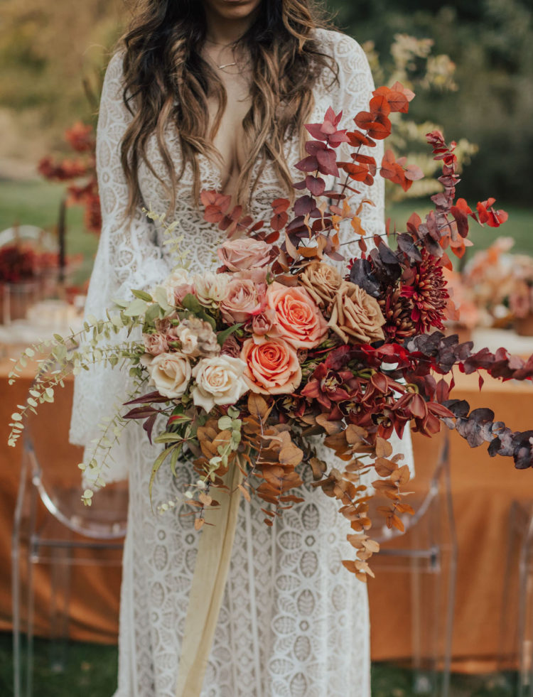 The gorgeous bridal bouquet was done with dried and fresh foliage, bold blooms and long ribbons