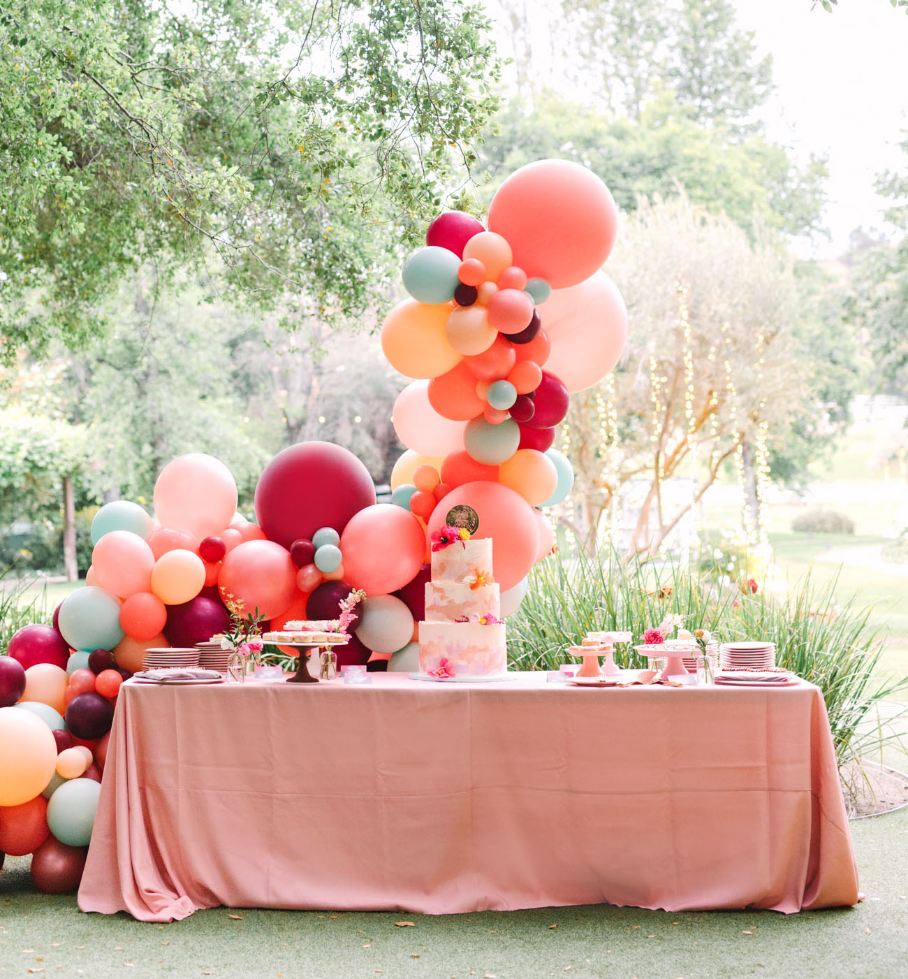 The dessert table was accented with a gorgeous colorful balloon arch behind it