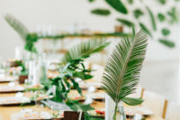 12 These tables with frond runners and centerpieces, tropical fruits and wooden chargers felt very tropical