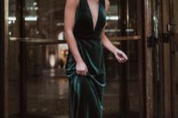 15 a forest green emerald maxi dress with thick straps and a plunging neckline plus statement earrings