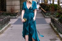 17 a teal wrap dress with an asymmetrical ruffle skirt, a gold clutch and studded shoes for a bold look in a traditional color