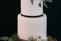 24 a modern white winter wedding cake with white blooms, gilded berries, evergreens and greenery