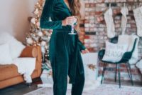 25 an emerald velvet jumpsuit with long sleeves, a V-neckline and metallic shoes for a refined look