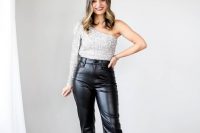 a NYE wedding guest outfit with black leather pants, a silver sequin one shoulder top, nude shoes with bows