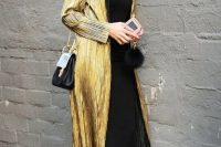 a black slip dress, black strappy shoes, a gold trench and a black bag for a wow look for a NYE wedding