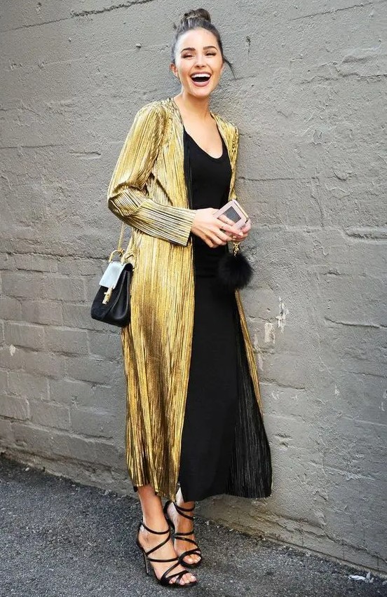 a black slip dress, black strappy shoes, a gold trench and a black bag for a wow look for a NYE wedding