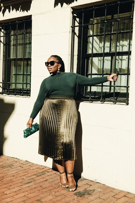 a catchy Christmas wedding guest look with a green top, a metallic pleated midi skirt, nude shoes and a small clutch