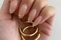 a classy glossy nude wedding manicure with gold touches is a lovely idea for a modern and elegant bride