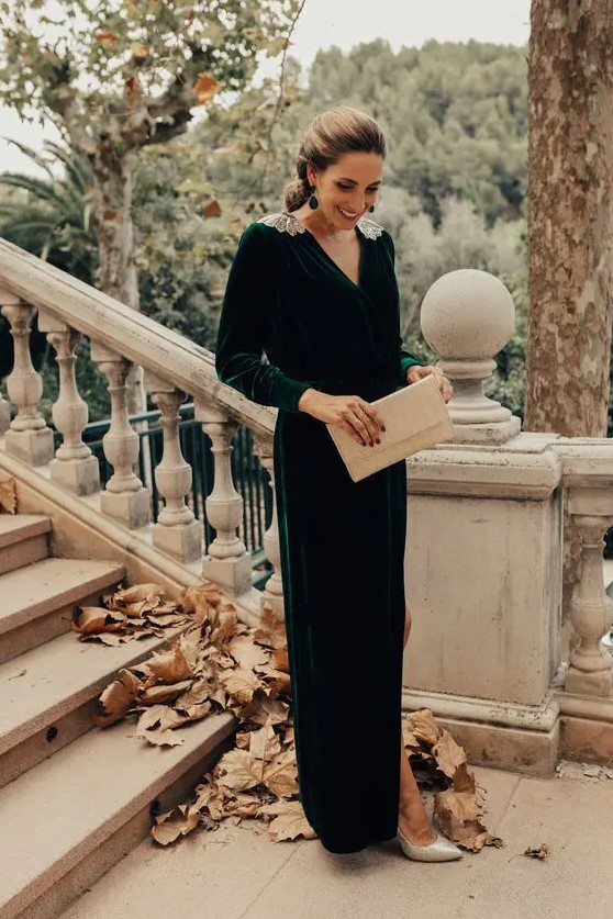 a hunter green velvet maxi dress with a V-neckline, embellished shoulders, silver shoes and a clutch plus statement earrings