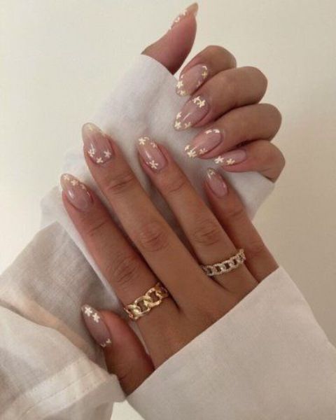 a nude wedding manicure with tiny gold flowers is a lovely solution for a wedding, it looks chic and lovely