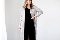 a shiny and bold NYE wedding guest look with a black one shoulder jumpsuit, a silver sequin midi cover up, nude shoes