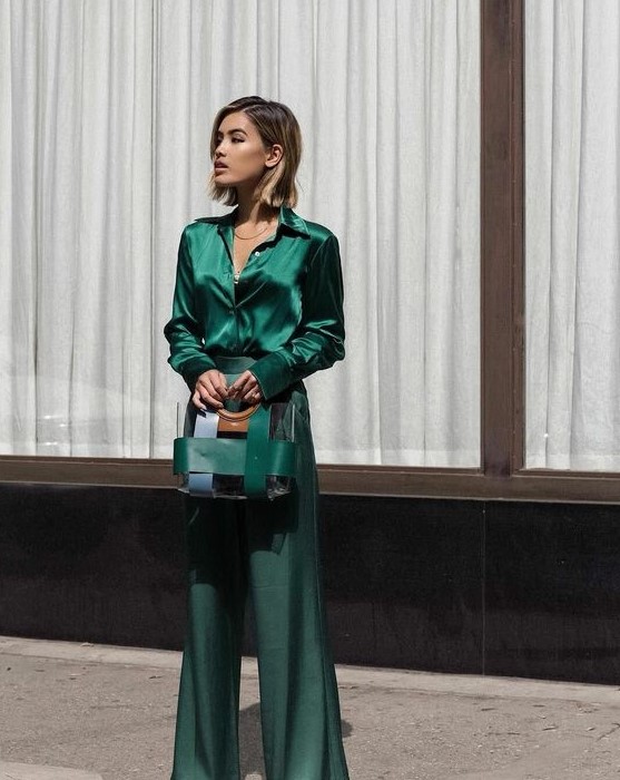 an emerald look with a blouse and flare pants, a stripe bag is a cool and chic idea for a Christmas wedding