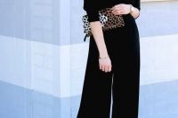 an off the shoulder black jumpsuit with wideleg pants, a leopard clutch and tassel earrings is a timeless solution