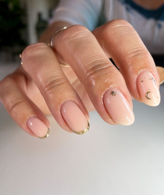 beautiful nude wedding nails with gold tips and gold celestial touches are a gorgeous solution for a celestial bride, they look chic