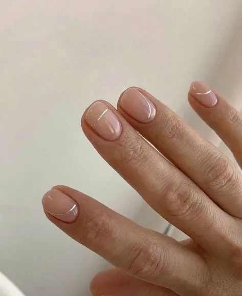 beautiful nude wedding nails with silver stripes are a trendy and modern solution for a bride