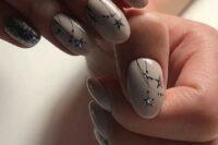blush starry night manicure with silver stars and silver accent nails for a winter or a starry night wedding