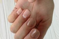 glossy and matte blush and taupe wedding nails with delicate botanical touches are beautiful and chic for a bride