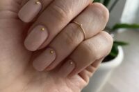 glossy nude nails with little gold studs is a delicate and girlish solution for many bridal styles