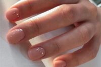 matte nude wedding nails with gold foil sprinkles are a fantastic idea for a wedding, they look glam and chic