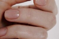 nude wedding nails with tiny gold studs attached are an amazing idea for a wedding, they look stylish, chic and timeless and can be worn afterwards