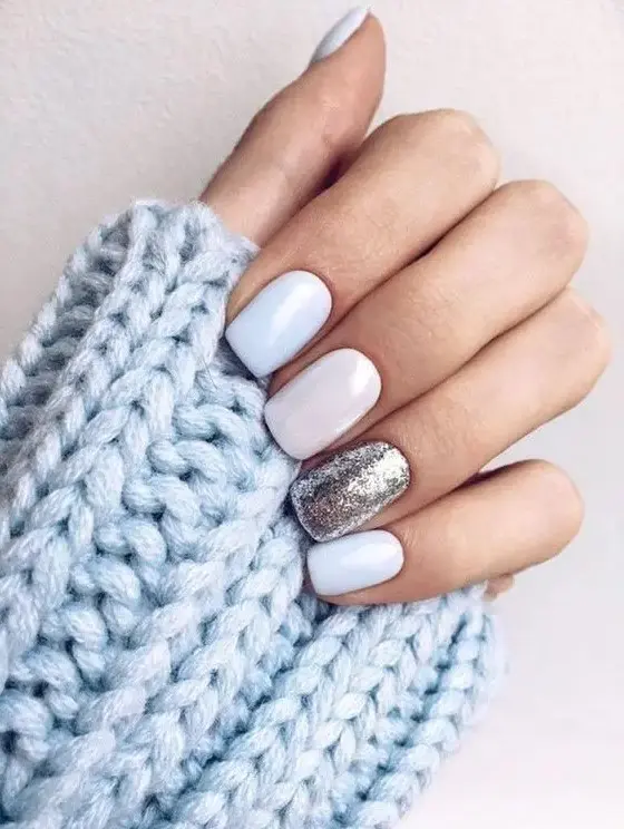 white and light blue and silver gltiter nails are beautiful for a chic winter bridal look