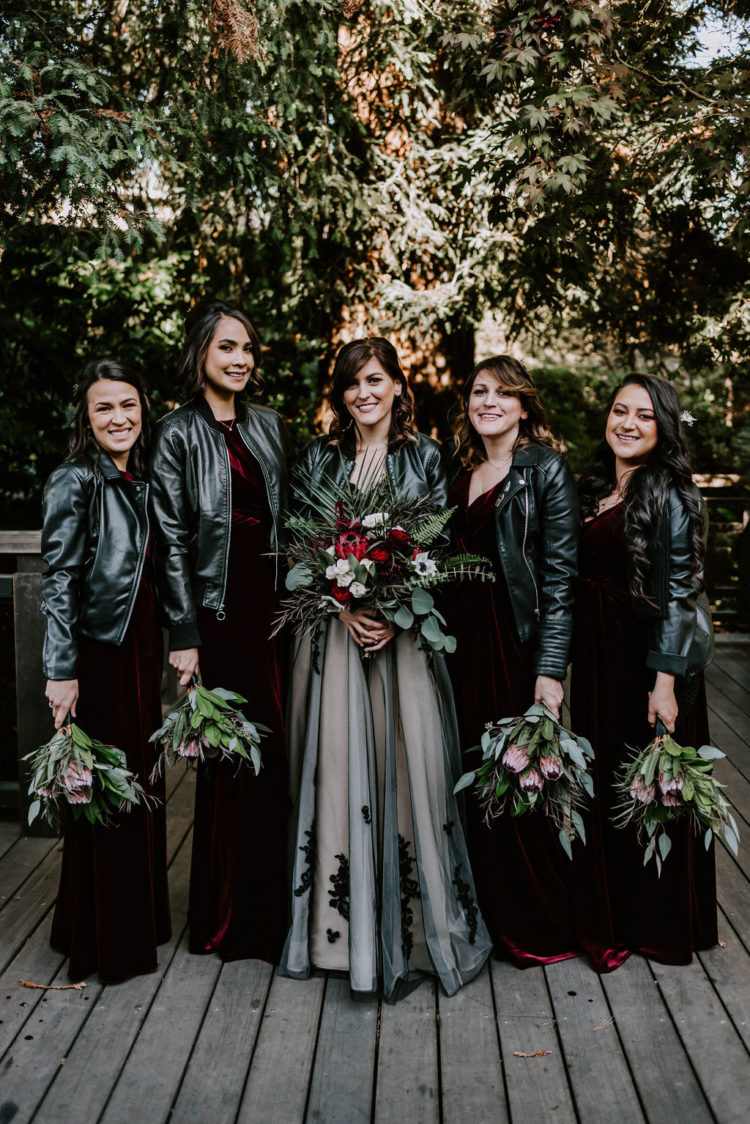 The bridesmaids were wearing mismatching burgundy velvet dresses and everyone covered up with a black leather jacket