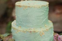 03 a textural aqua-colored wedding cake decorated with gold leaf looks very cool and bright