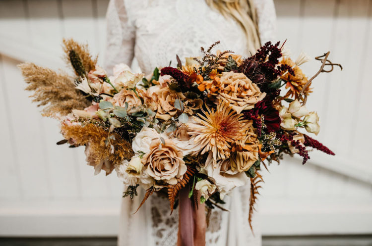 The wedding bouquet was done in rust, burgundy and peachy with pampas grass and dried herbs