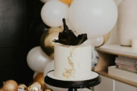 04 The wedding cake was a white one, decorated with black shards and with gold leaf