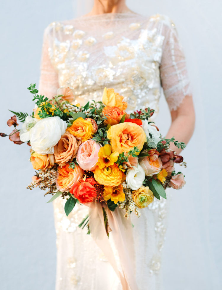 Look at the fantastic wedding bouquet with lush blooms in sunny shades