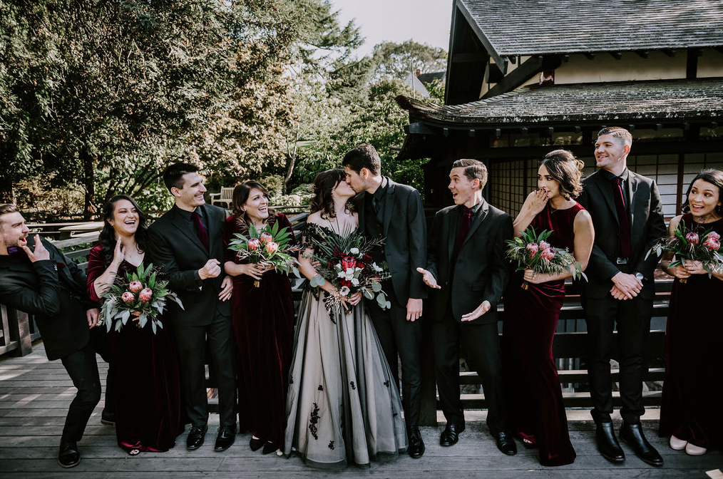 The groom and groomsmen were wearing black, and guys were rocking burgundy velvet ties