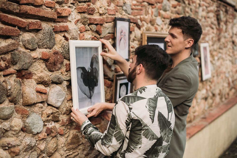 The groomsmen hung some cool artworks all over the space to create a gallery wall