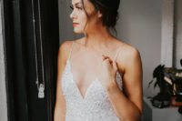 06 The bride was wearing a beautiful embellished sheath wedding dress with a deep neckline and spaghetti straps