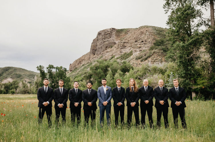 The groom was wearing navy, and the groomsmen rocked black suits with black ties