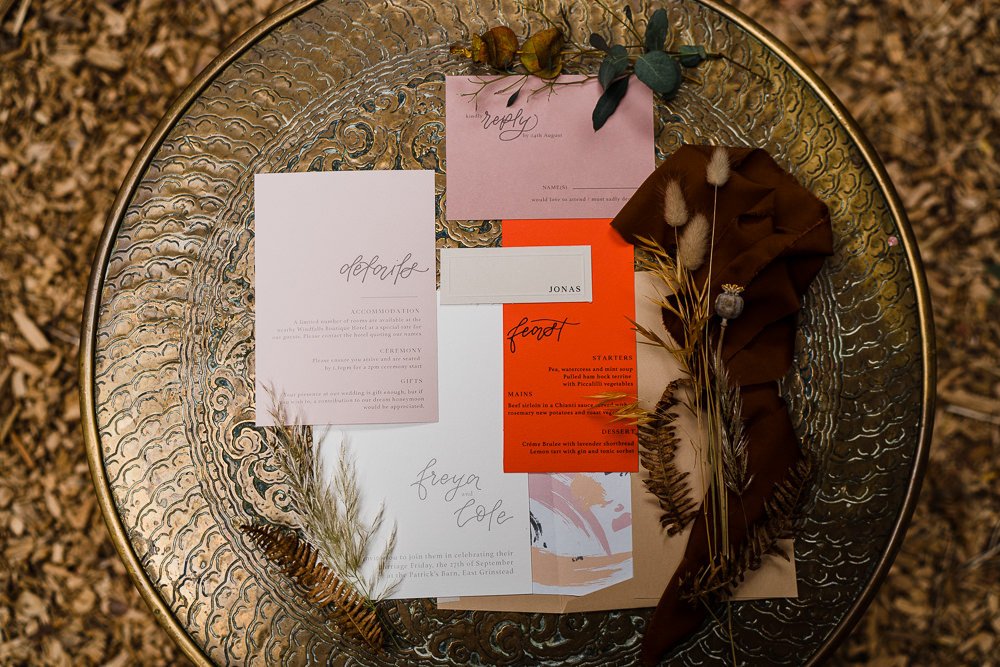 The wedding stationary was done in orange and pink and with watercolors