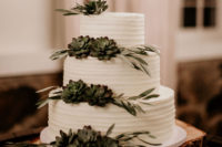 07 The wedding cake was simple and rustic, with greenery and succulents