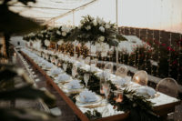 08 The table was set with white blooms and greenery, centerpieces and a runner, and with touches of gold for more chic