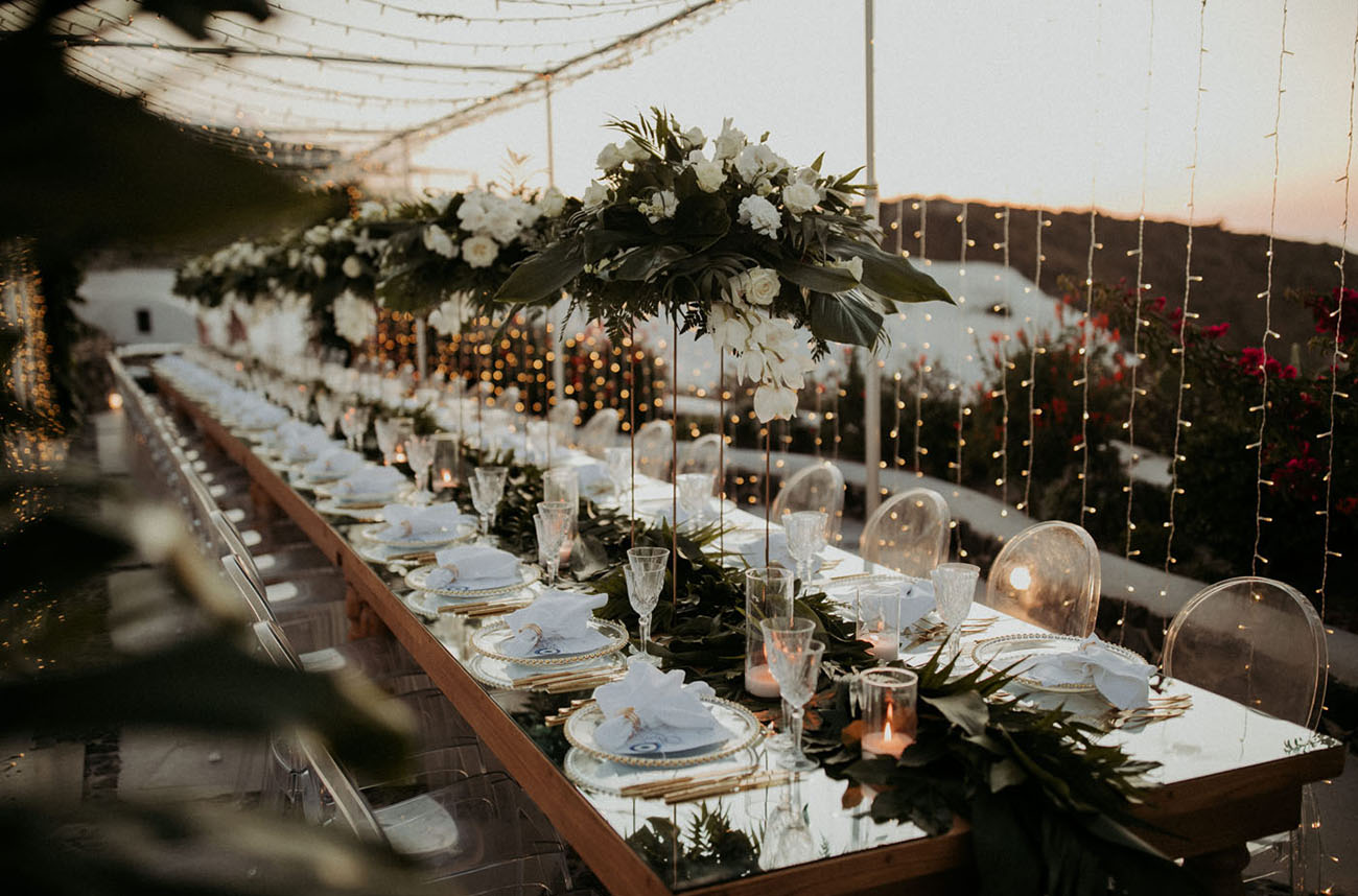 The table was set with white blooms and greenery, centerpieces and a runner, and with touches of gold for more chic