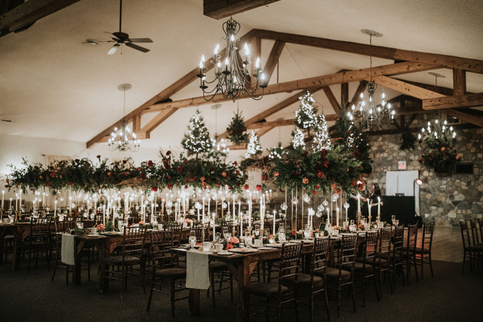 The venue was gorgeous festive, with pink and red blooms, evergreens and lots of candles