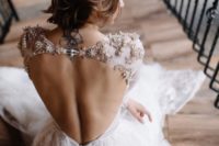 08 a beautiful lace wedding dress with an open back and gorgeously embellished shoulders plus a couple of buttons