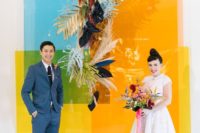 08 a crazy and bright color block wedding backdrop done with dried fronds, pampas grass and dark blooms