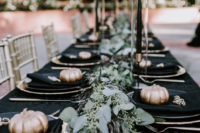 08 the reception tables were done in black and gold, with black candles and gold pumpkins
