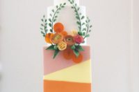 10 a modern and cute wedding cake with bright color blocking and natural and sugar blooms and greenery