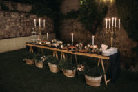 11 The sweets table was styled in a very elegant way, with candles, sweets and baskets with greenery